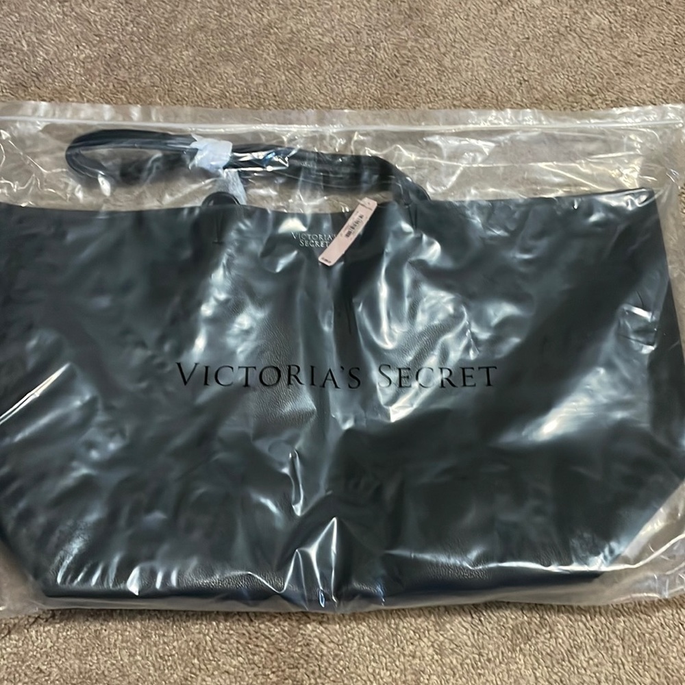 Black leather Victoria’s Secret bag. Still in plastic wrap. Never been used!